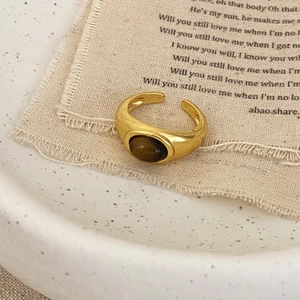 Retro gold wide open ring with oval brown cat-eye gemstone in a minimalist vintage style