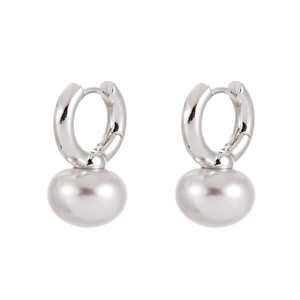 Macro view of hoop earrings featuring flat round purple pearls and silver metal hooks