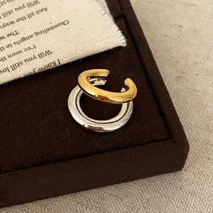 Two-tone C-shape double cuff earring in gold and silver finish on vintage velvet box