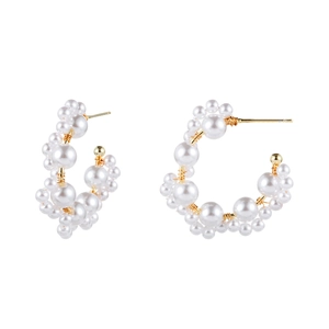 Elegant gold-tone C-shape hoop earrings with layered white pearls in various sizes