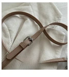Detail of adjustable khaki leather strap with silver buckle and fine stitching