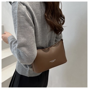 Detail of dark brown leather shoulder bag with FASHION & BAGS print and silver zipper