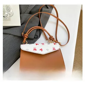 Detail showing cartoon bear print flap and brown leather finish of the crossbody bag