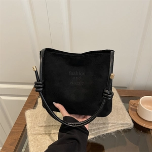 Sac seau chic en daim noir avec bandoulière nouée et détails en métal doré