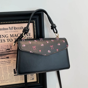 Sweet black cherry-style handbag with floral bow flap and knotted handle decoration