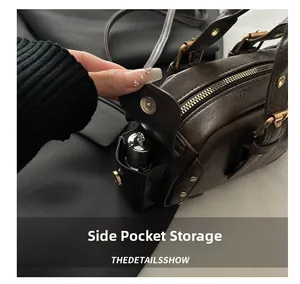 Detail view of the side pocket on a vintage brown leather bag for small items