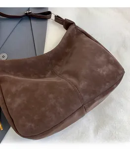 Close-up of vintage dark brown suede tote bag with soft texture and refined stitching