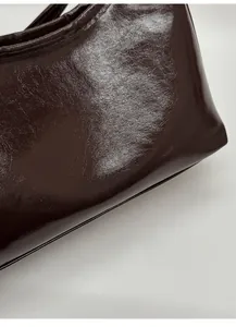 Detail of dark brown oil wax leather tote with Fashion & Bags printed text on side