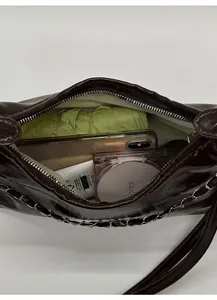 Detail view of large capacity tote bag interior with mobile phone and cosmetics