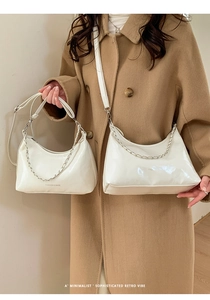 Detailed comparison of large and small white glossy leather crescent bags with chains