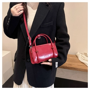Detail of red leather crossbody bag with Fashion embossing and polished finish