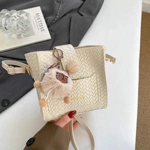 Minimalist beige woven leather bucket bag with wooden buckle and cute bear charm