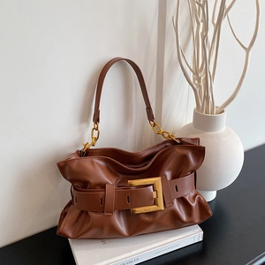 Brown pleated cloud bag with large gold buckle and metal chain strap in soft leather