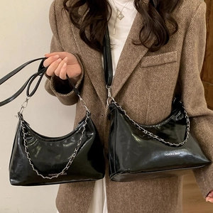 Fashionable black glossy crescent tote bag with silver chain and leather shoulder strap