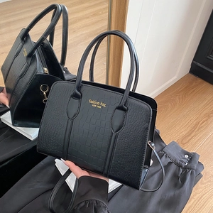 Minimalist black crocodile pattern tote bag with gold lettering and top handles