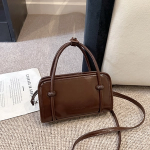 Dark brown glossy leather rectangular handbag with thin handles and shoulder strap