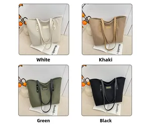 Detailed view of corduroy tote bags in white, khaki, green and black with logo plates