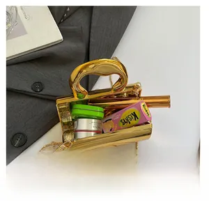 Detailed top view of a gold metallic mini box bag showing its internal storage capacity