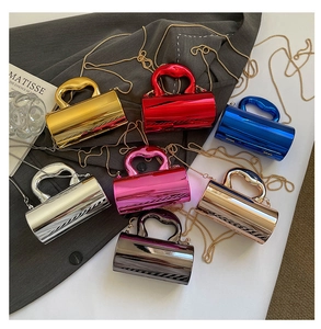Detailed view of colorful metallic acrylic cylinder bags with sleek handles and chain straps