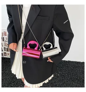 Detail of rose red and silver mirror-finish acrylic cylindrical bags with heart handles