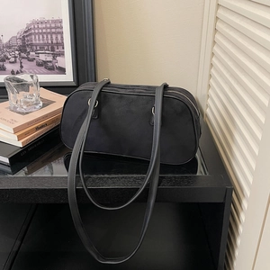 Minimalist black suede baguette shoulder bag with long dual straps in retro style