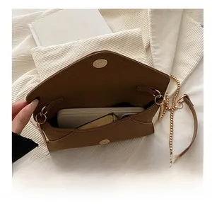 Interior view showing the storage capacity of the brown envelope chain crossbody bag