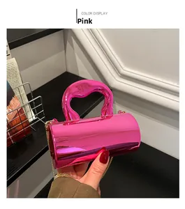 Detail of pink cylindrical acrylic bag showing metallic mirror finish and golden chain