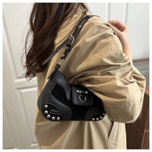 Detail of black Y2K shoulder bag with silver rivets and smooth PU leather texture