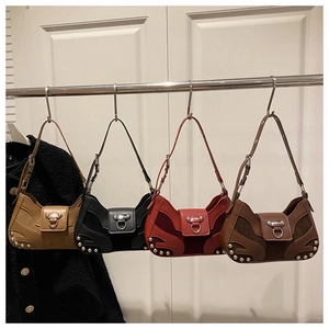 Detail view of four retro punk style bags with metal studs and flame pattern accents