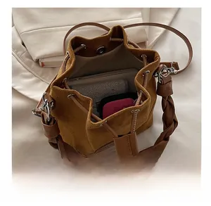 Suede bucket bag interior view showing large capacity for tablet and accessories