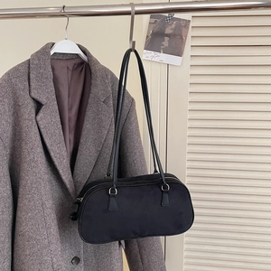 Classic black suede Boston bag with large capacity for women on gray coat background
