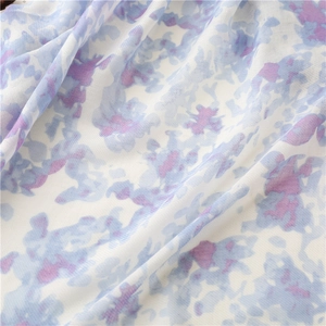 Close-up of linen-feel scarf showing blue and purple floral ink painting print and fabric texture