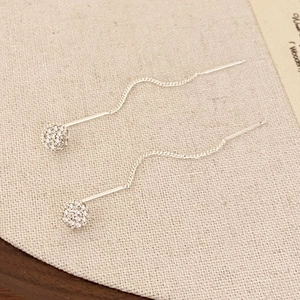 Detail of 925 silver threader earrings featuring sparkling cubic zirconia pave balls