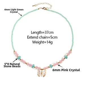 Detail of beaded necklace with light green crystals and white butterfly pendant