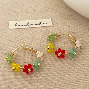 Handmade floral beaded earrings with colorful petals and gold wire-wrapped hoops