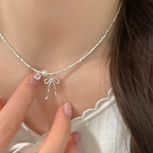 Silver bow necklace with pink heart pendant and white pearl on twisted rope chain