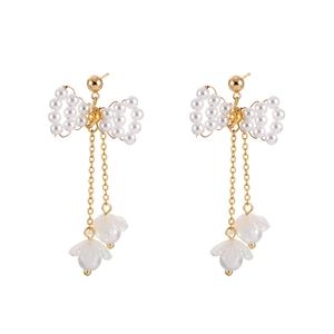 Elegant gold bow earrings with pearl tassel and flower pendants on white background