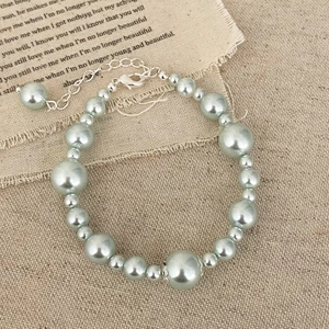 Elegant pearl bracelet with silver lobster clasp and extender on a vintage rustic background