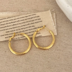Classic gold hoop earrings with thick textured stripes and elegant minimalist design