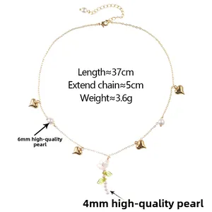 Détail du collier floral doré avec perles, cœurs et spécifications de chaîne de 37 cm