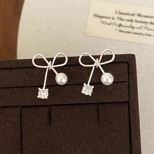 Elegant bow-knot earrings with silver twist texture, white pearls and zircon accents