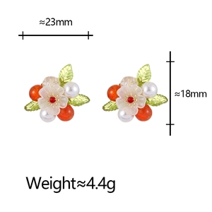 Detailed view of floral stud earring with orange beads and pearl showing 23mm width dimensions
