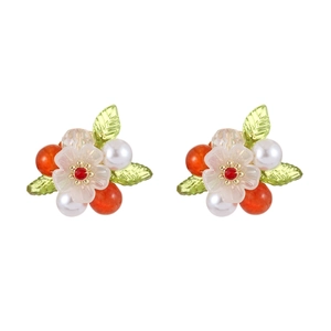 Floral stud earrings featuring white petals, pearls, and green leaves on white background