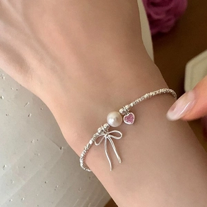 Sparkling silver necklace with large white pearl, pink heart gem and bow pendant for women