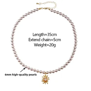 Detail of 6mm pink pearl necklace with golden sun pendant and 5cm extension chain