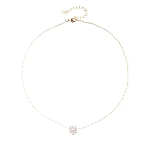 Minimalist gold chain necklace featuring a white pearl flower cluster pendant on white backdrop