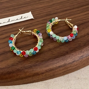 Handmade colorful beaded hoop earrings featuring faceted crystals on gold wire hoops