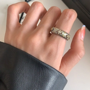 Detail of vintage textured gold ring with inlaid zircon stars worn on a finger