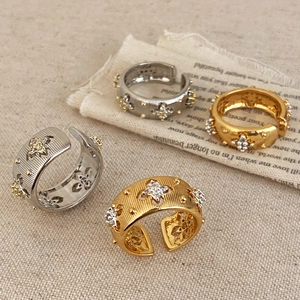 Detailed view of vintage brushed rings with cubic zirconia stars in gold and silver