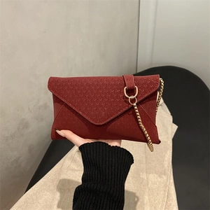 Burgundy envelope clutch bag with woven texture and gold chain strap for women